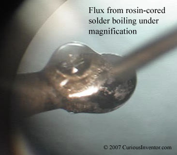 Flux fumes from iron tip under 30x magnification